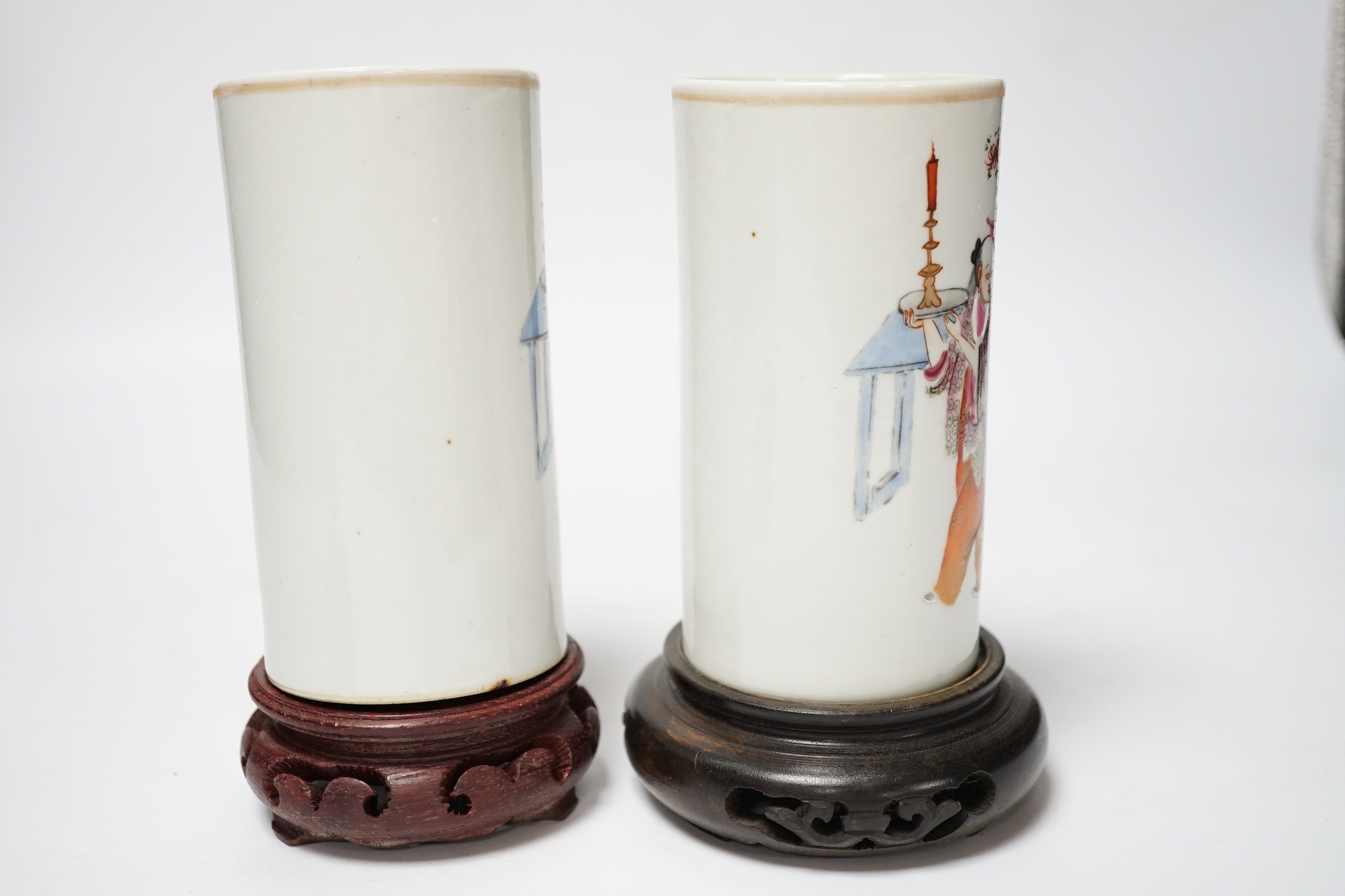 A pair of Chinese cylindrical famille rose brush pots on associated stands, largest 15cm high overall